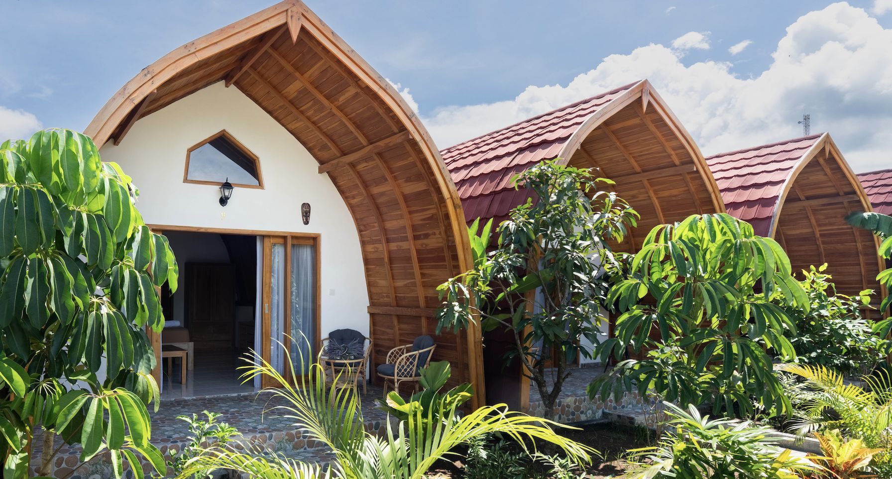 Wooden bungalows surrounded by tropical garden at Arc Villas Bali